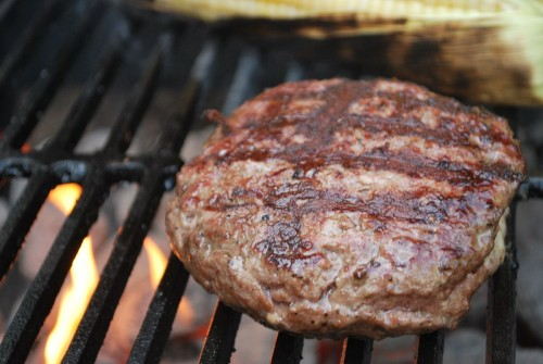 Make sure that you grates are heated before starting to grill the burger.  You want it to sear the outside to keep the stuffing on the inside.  You know your grates are hot enough when you can only put your hand above them for 3-4 seconds.