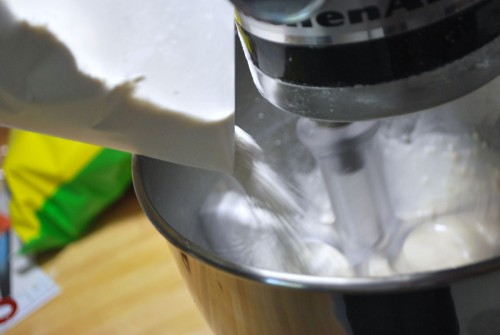 If you sift the flour onto a piece of wax paper you can easily funnel it into the mixing bowl.