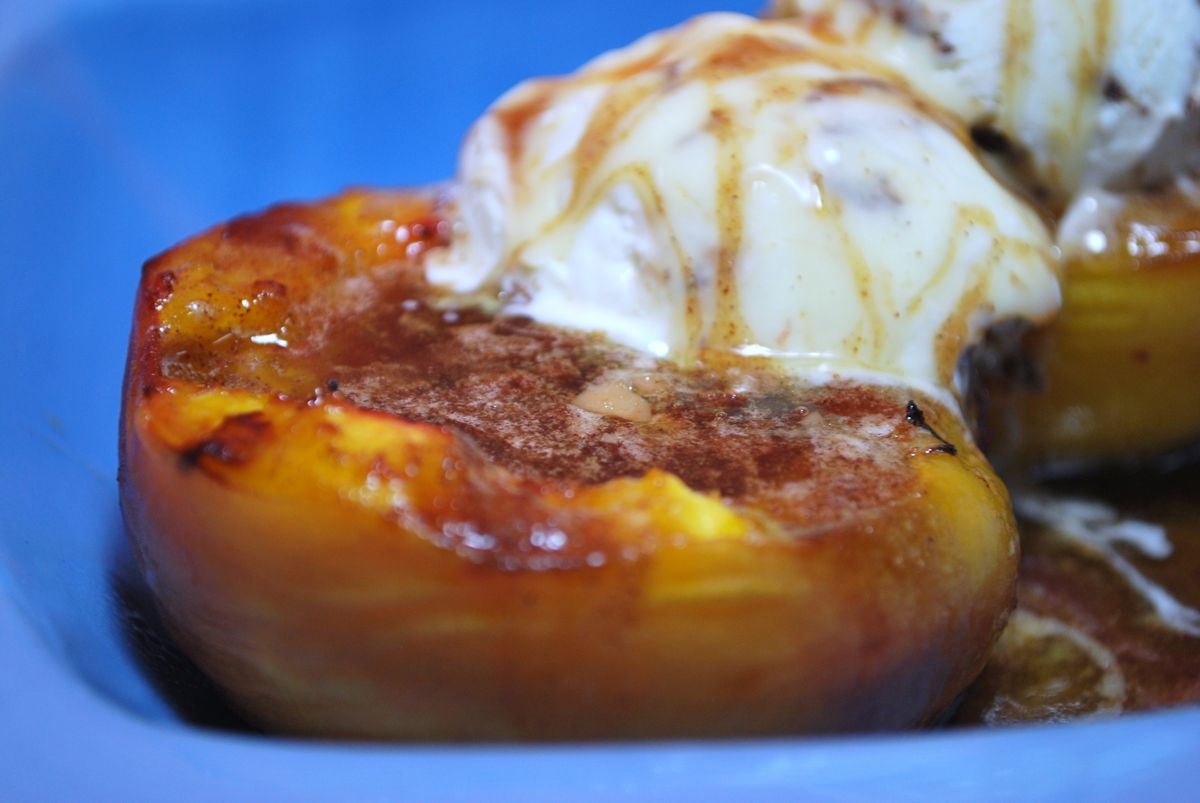 Grilled peaches topped with ice cream
