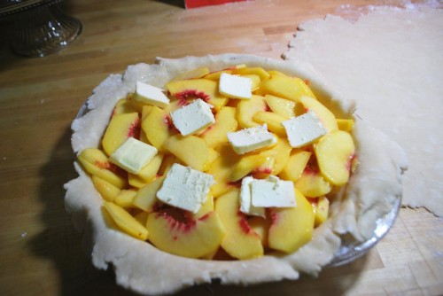 Add the peaches and dot with butter