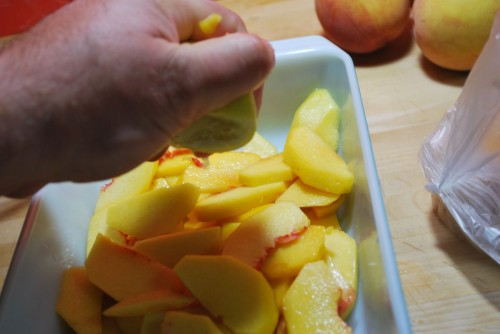 Lemon juice will keep the peaches until you are finished with the crumb topping