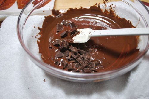 Add unmelted pieces to the chocolate to help temper it
