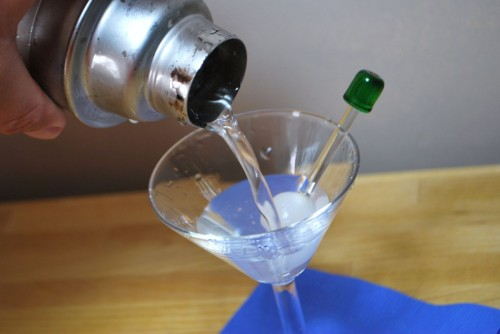 Strain the vodka into the glass lined with vermouth