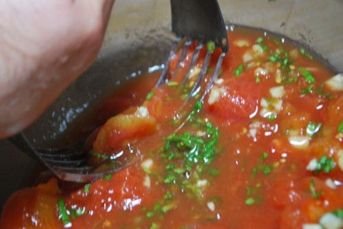 Crush the tomatoes to make the sauce