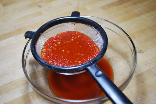 Strain to extract the spicy red sauce