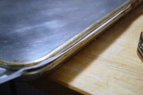Sandwich the pastry between two sheet pans.