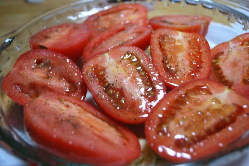 Tomatoes ready to roast, arrange cut side up.