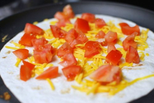 Top with cheese, tomatoes and onions