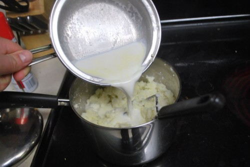 Add the cream to the potatoes