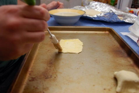 Spread out the puff pastry and paint with egg wash
